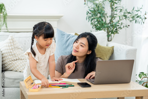 Canvastavla Caring Asian mother points toward crayon box while preschool daughter chooses color from table, practicing art, decision making, early learning, mother child connection during homeschool indoors