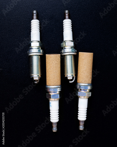 4 sparkplugs with some with cardboard tubes