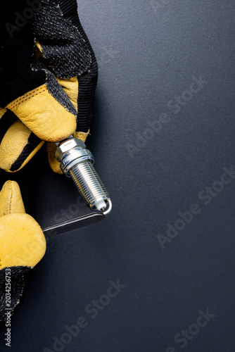 Closeup of a mechanic using a feeler gage spark plug