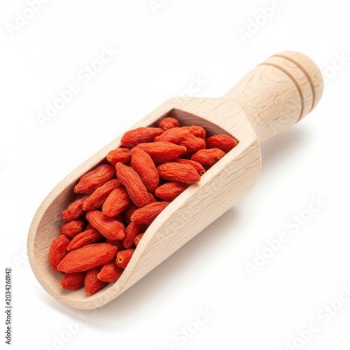 Wooden scoop filled with dried red goji berries on white background