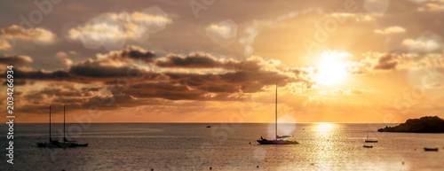 Magnificent sunset above the Mediterranean Sea and sailboats silhouette. Ibiza, Spain