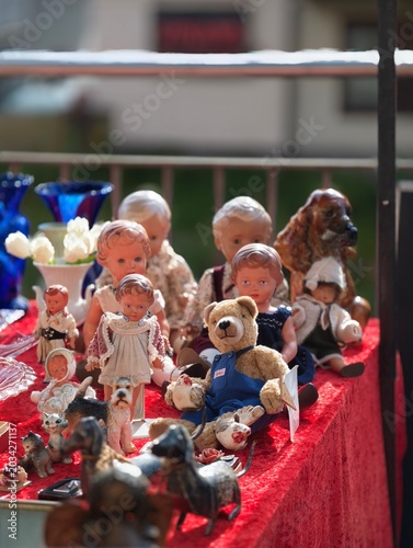 Handcrafted Dolls With Painted Features On Sunny Outdoor Stall