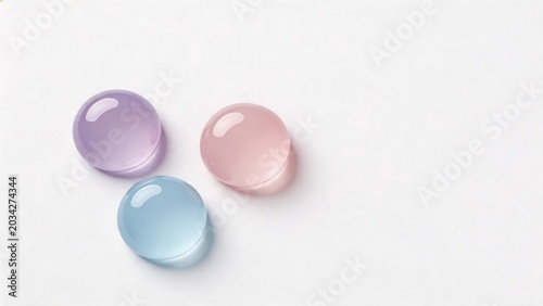Colorful glass spheres on white surface
