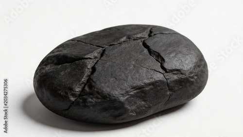Cracked black stone on white surface