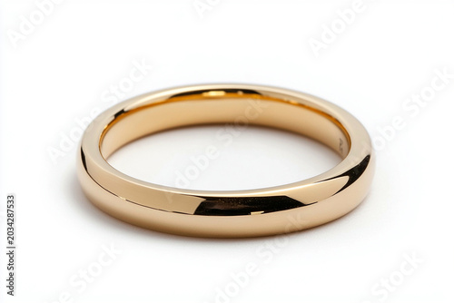 Gold wedding band on white background symbolizing commitment