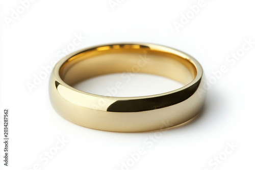 Gold wedding band on white background symbolizing commitment