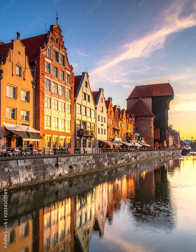 Fototapeta premium Historic waterfront buildings reflect in calm water