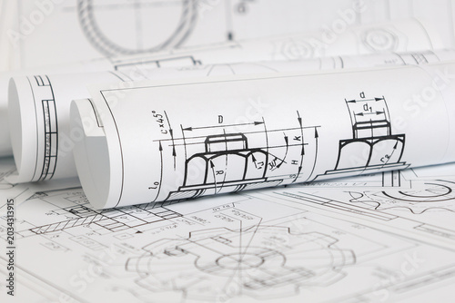 paper engineering drawings of industrial parts and mechanisms