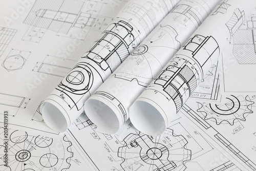paper engineering drawings of industrial parts and mechanisms