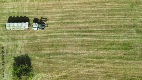 Aerial View of Tractor Working on Hay Field in Rural Countryside