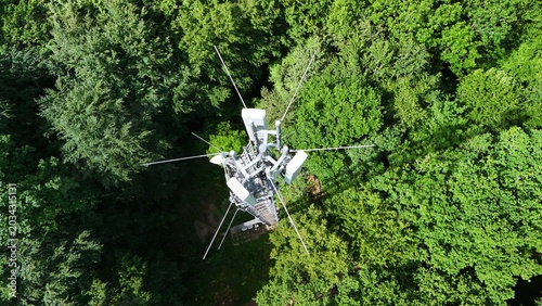 Cellular Communication Tower Above Dense Green Forest Landscape