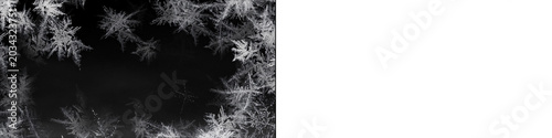 White frost frame creates wintry ice crystal border around black background for holiday season graphic designs.
