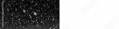 Dense blizzard snow falling down with soft bokeh particles and sharp flakes for winter atmosphere composition.