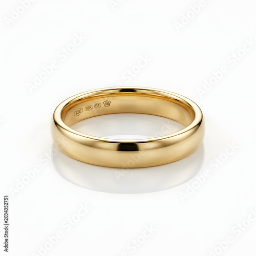 Classic polished 18k yellow gold wedding band isolated on white background featuring hallmark engravings and crown symbol for traditional marriage and commitment ceremony.