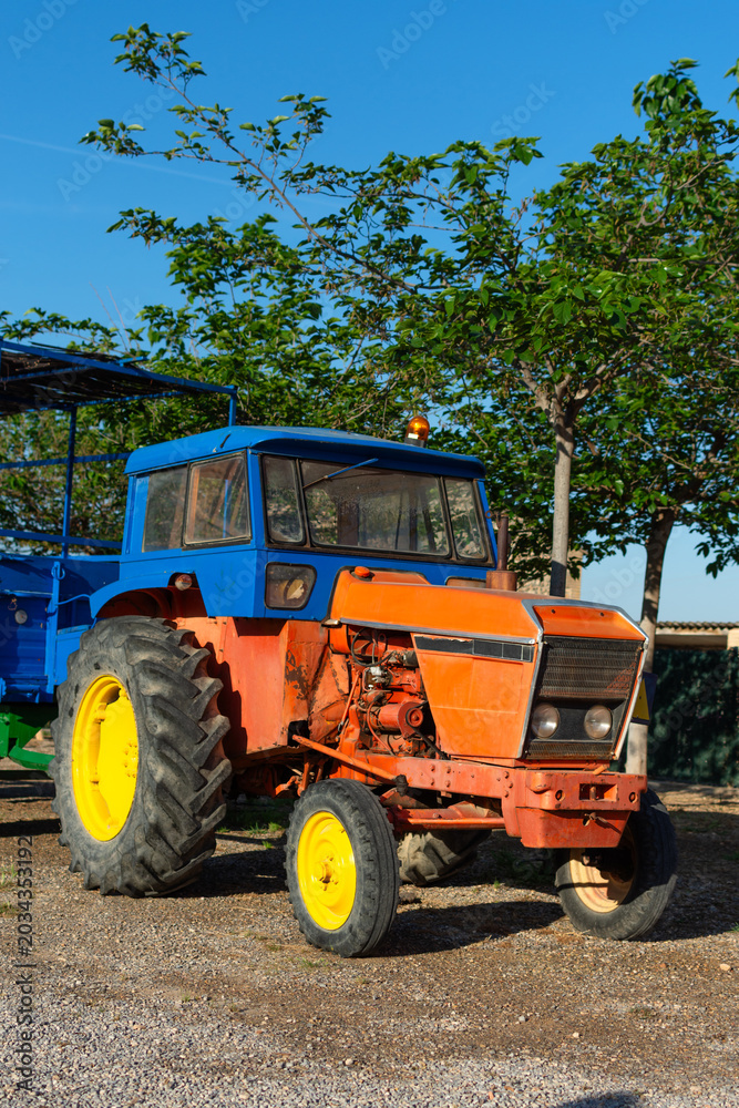 Fototapeta premium vertical view of old tractor with trailer in field