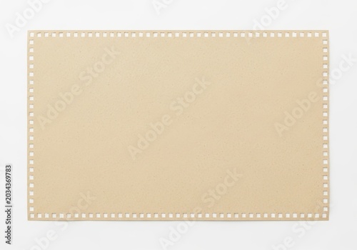 Perforated beige cardboard sheet ready for cutting or crafting projects