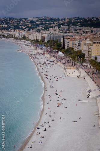 Panoramic aerial view of a beautiful sandy beach with crystal-clear turquoise water along the Mediterranean coastline near Nice on the French Riviera