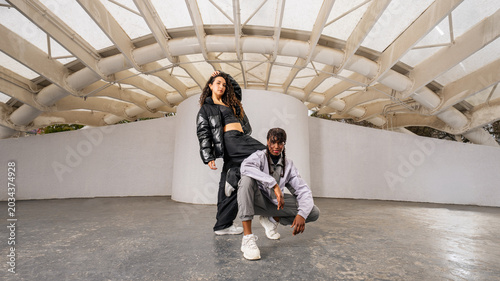Fotografija Young female hip hop urban dancers posing  against a striking modern background
