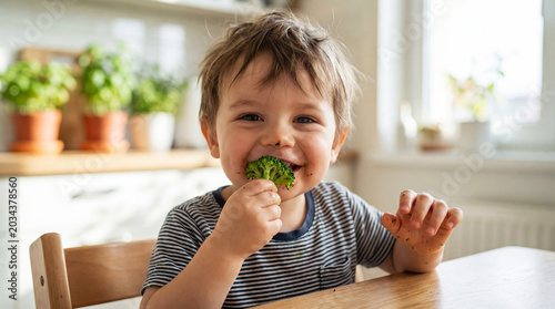 Little boy eating broccoli. Agriculture and healthy food concept. World Vegan Day