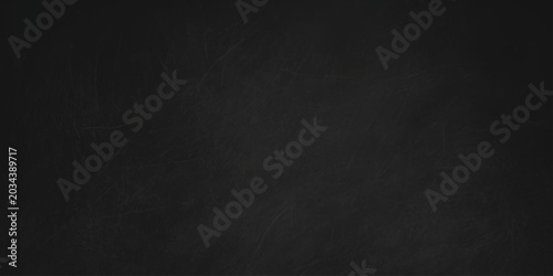 Photos Black chalkboard background with subtle chalk dust texture and faint streaks for design overlay