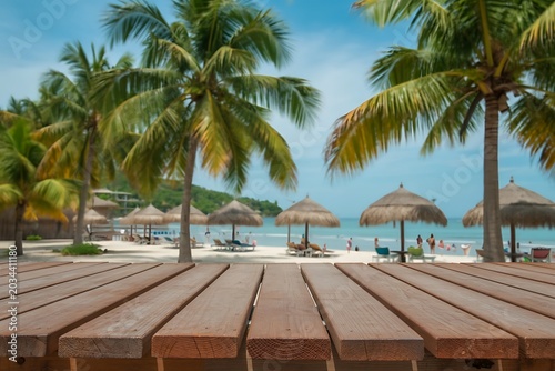 Empty wooden table background with beach resort restaurant palm trees banner mockup