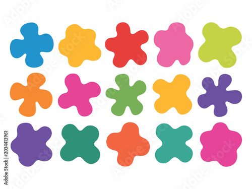 A colorful arrangement of flower-shaped objects in various hues on a white background