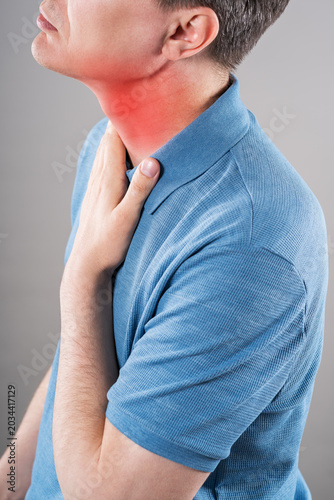 Fotografía Thyroid gland inflammation, sore throat and cough, man with neck pain on gray ba