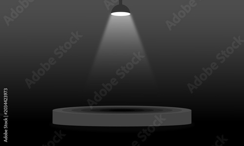 Spotlight Beam on Gray Circular Stage in Dark Room
