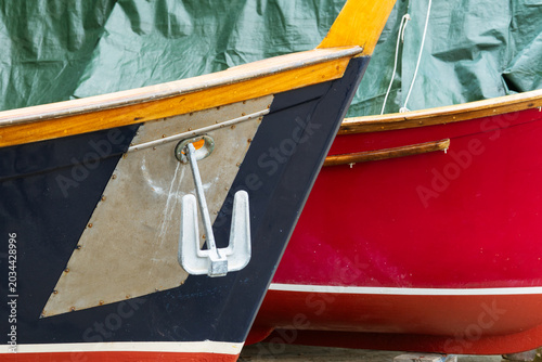 Schilderij op canvas Close-up of two colorful wooden boats docked side by side