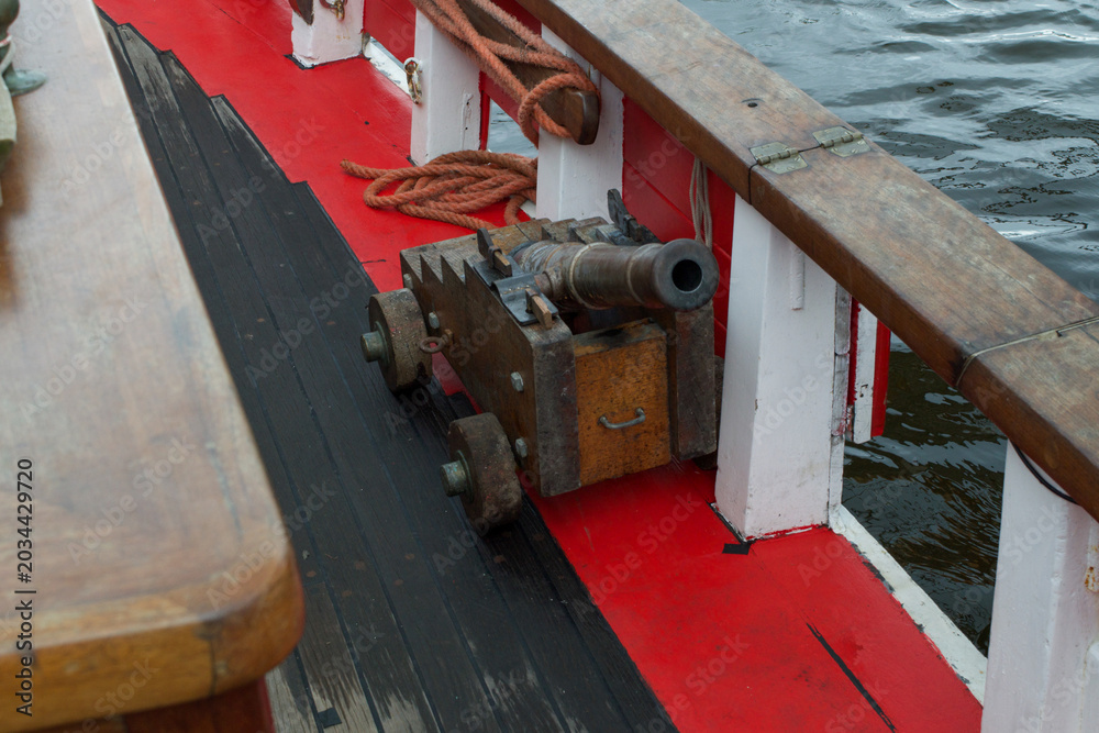 Fototapeta premium Cannon in a ship. A small four inch blank firing cannon used for historical reenactments or naval battles.