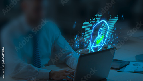 Identity Authentication Technologies. Secure Passwordless Multi-Factor Authentication. Businessperson Tapping Laptop to Use Authenticator Application.