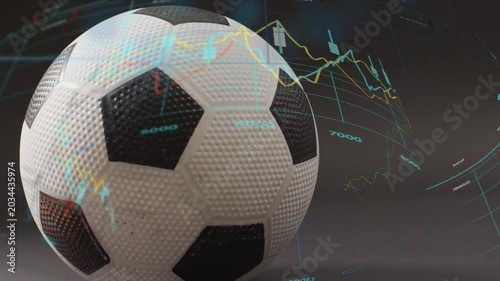 On play textured B and W soccer ball rotating while holographic charts rising to show market trends
