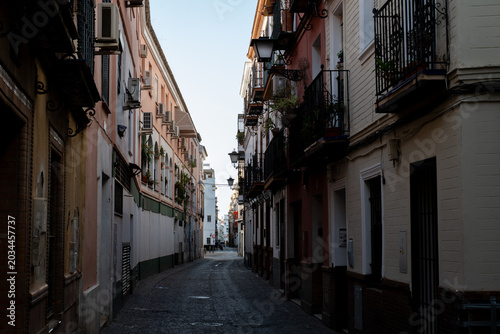 Narrow cobblestone street San Luis in the historic old town of Seville Spain