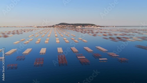 The Thau lagoon and its tables at sunset