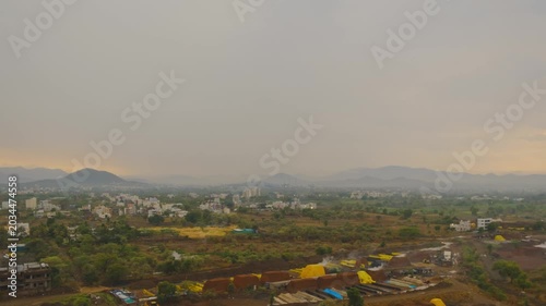 Wide angle view of Pune, timelapse of a windy rainy  sunset over the hills.