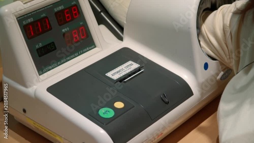 Automatic blood pressure monitor stand in the hospital table.