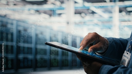 Konstfotografi Close up of data center engineer using AI software on tablet to optimize performance and forecast issues, Programmer integrating artificial intelligence automation in data center operations, camera A