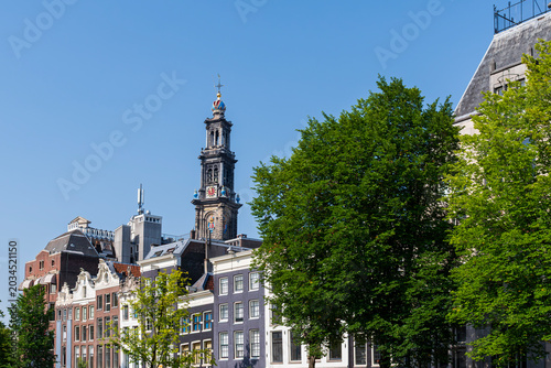 landmark church tower above commercial buildings in amsterdam netherlands