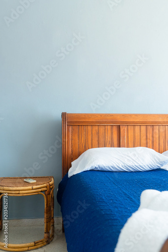Clean guest room with comfortable bed and wooden headboard