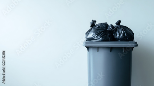 Obraz na płótnie Overflowing trash bin with black garbage bags