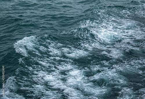 white foamy waves on the sea surface.