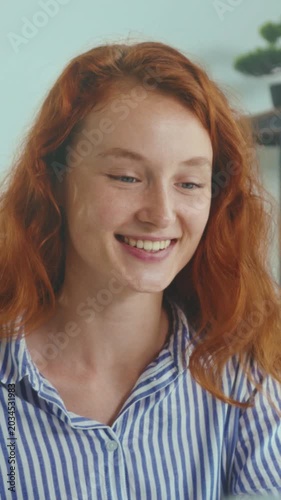 Focused freelancer typing at home desk, Joyful Caucasian redhead working diligently in home office environment