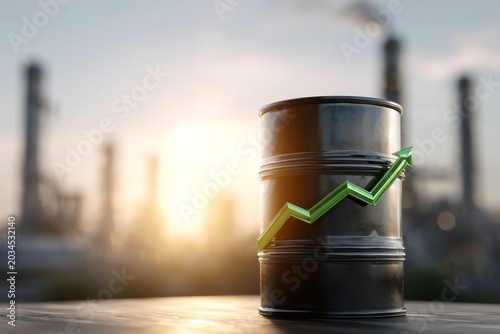 Close-up view of black oil barrel with upward green arrow against industrial background