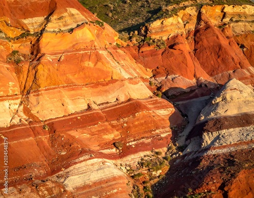 Vibrant Layered Sandstone Cliffs Glowing in Sunlight in Arid Canyon Landscape