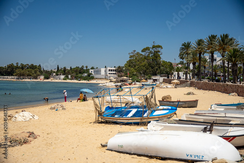Fishing net draped overa  fishing boat on the beach in Hammamet, Tunisia