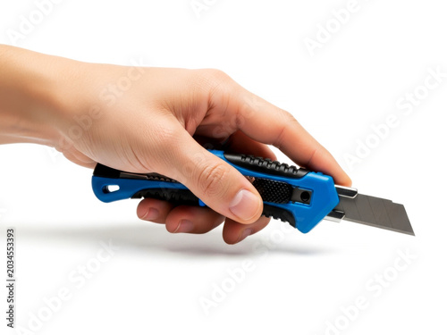 Human hand holding sharp metal box cutter utility knife tool isolated on white background for hardware work