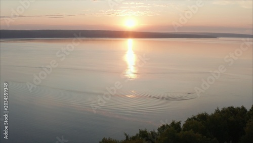Beautiful, bright sunrise over the lake. Sunset over the drone reservoir frames