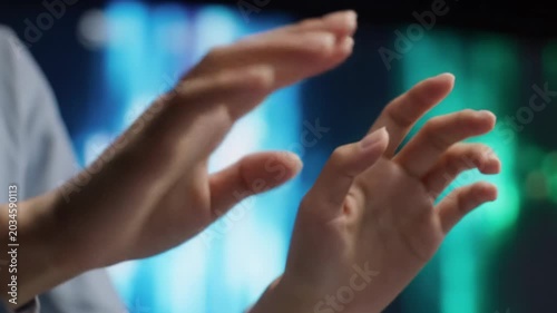 Ultra-close-up of gender-neutral hands, business-casual sleeve, precisely typing, swiping on futuristic interface, with vibrant blue, green, white bokeh. Technological mastery concept.
