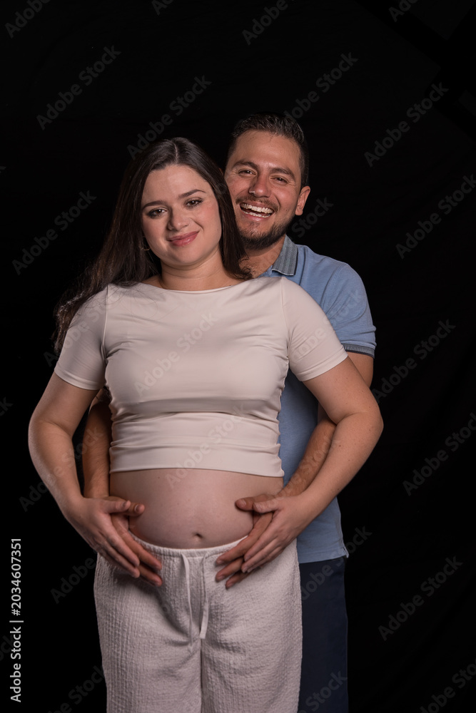 Fototapeta premium Expectant Couple Portrait Smiling Together in Studio