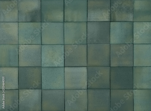 Blue-green terracotta ceramic tiles cladding texture for interior, exterior wall, dividing wall, facade, yard, floor. Natural handmade tinted bluish green outdoor square clay slabs background.